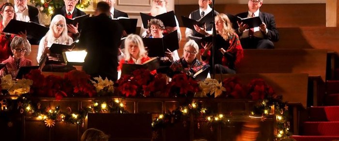 An audience lit from the stage during a performance
