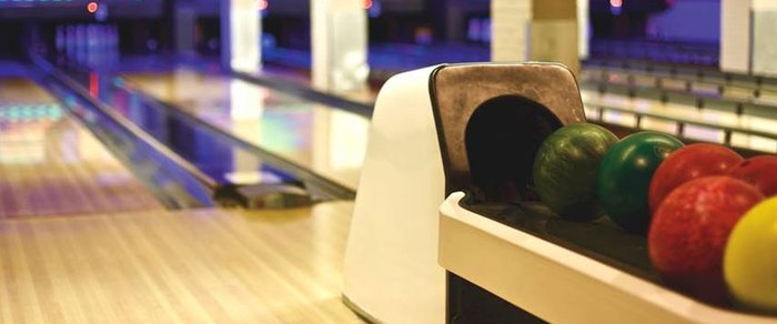 A ten-pin bowling lane with pins set at the far end