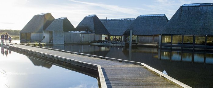 Buildings on a floating pontoon on a lake at Brockholes