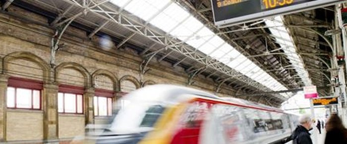 A train at a platform seen in motion