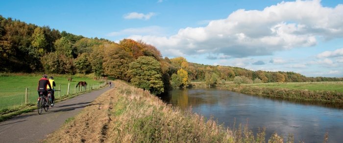A cyclist on the surfaced riverside path outside Preston