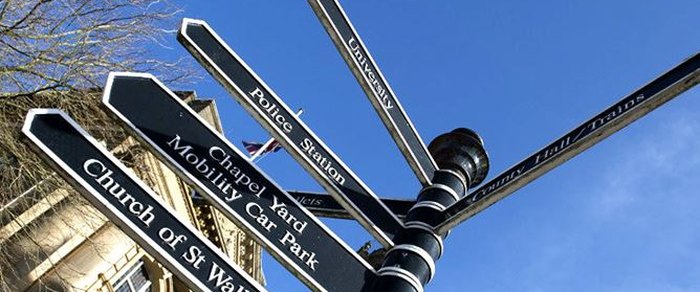 A close view of a Preston city-centre direction sign